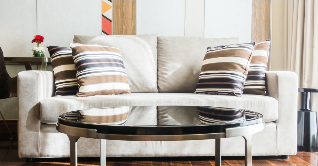 "Modern and affordable furniture pieces arranged stylishly in a contemporary living room setting, showcasing comfortable sofas, sleek coffee tables, and chic home decor. Ideal for those seeking stylish yet budget-conscious interior design solutions."